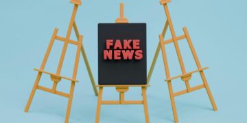 tanda berita palsu yang duduk di atas kuda-kuda